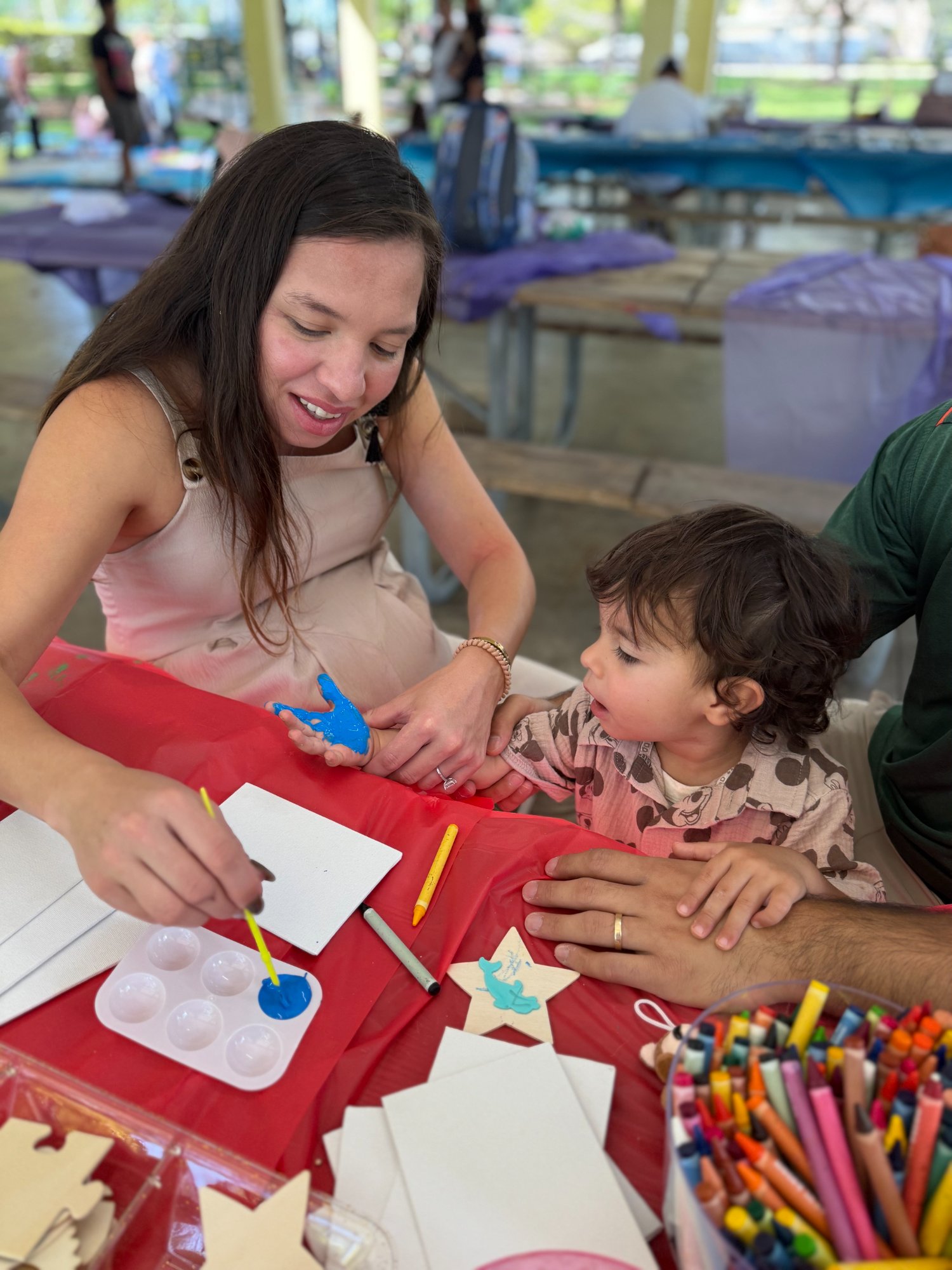Therapist helping child with activity at community event