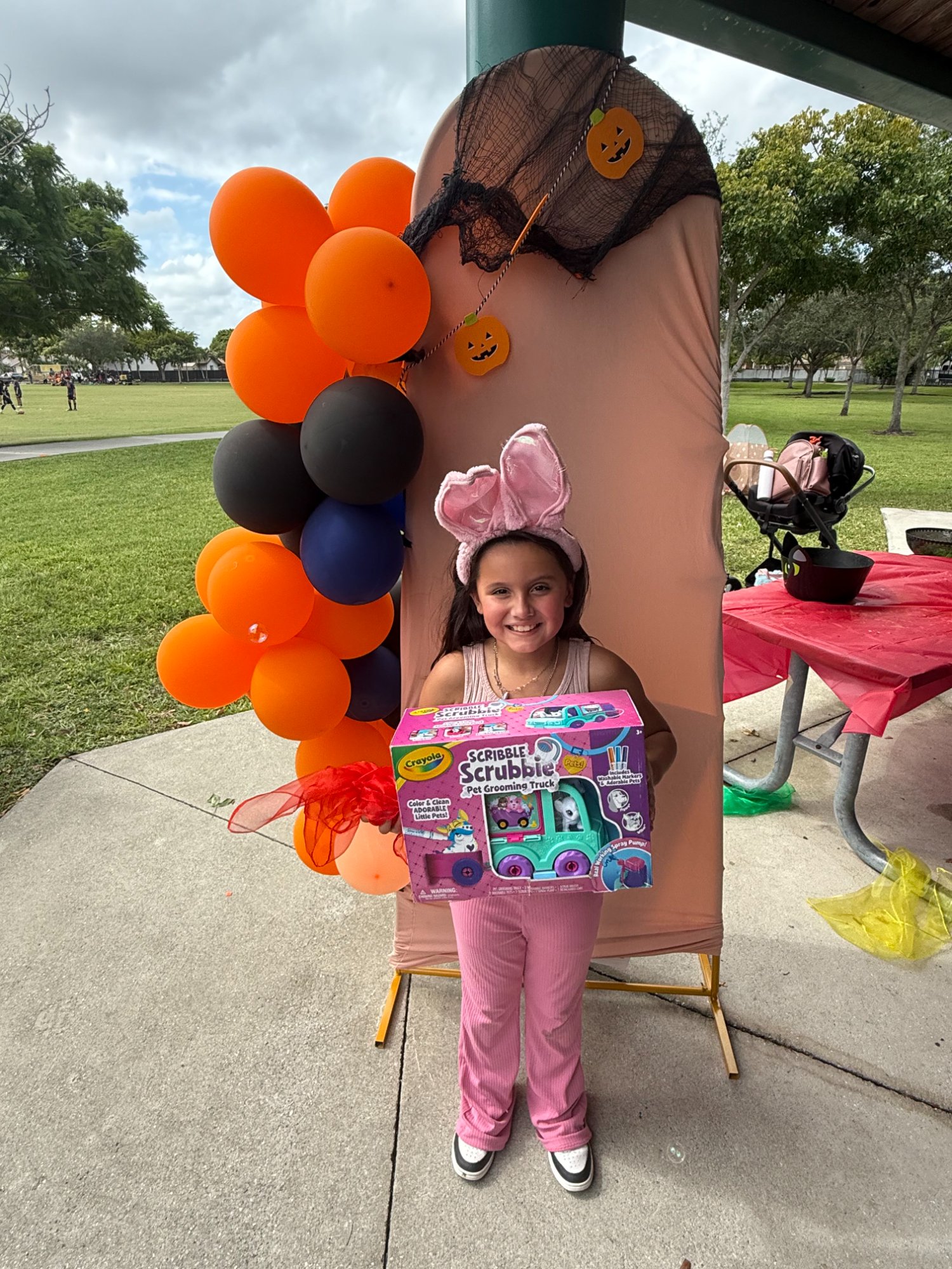 Girl in pink with prize at community event