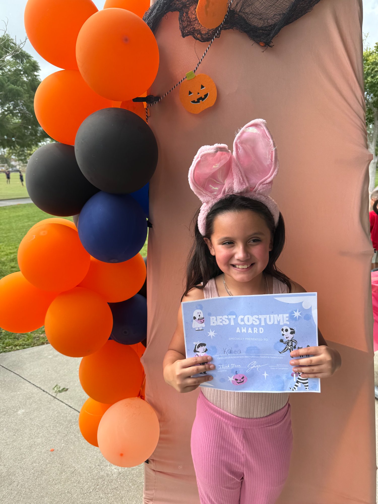 Girl with best costume award certificate