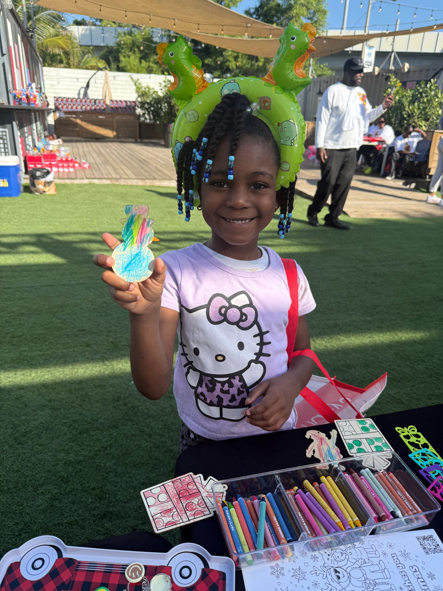 Girl showing her colorful craft creation