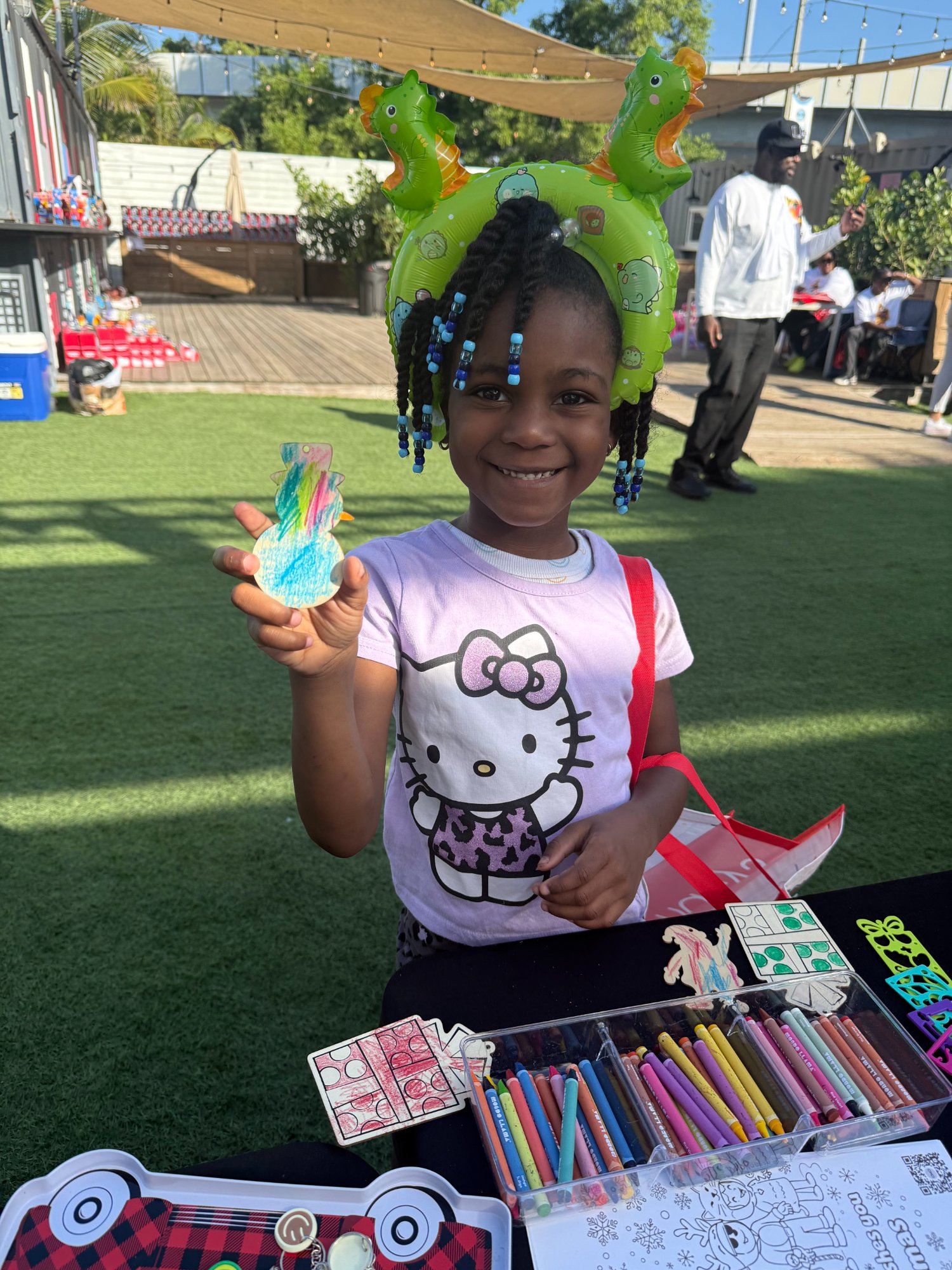 Smiling child with colorful craft project