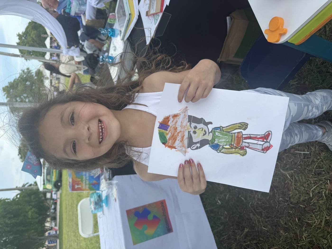 Bright colors, bigger smiles — a young artist shows off the masterpiece they mad