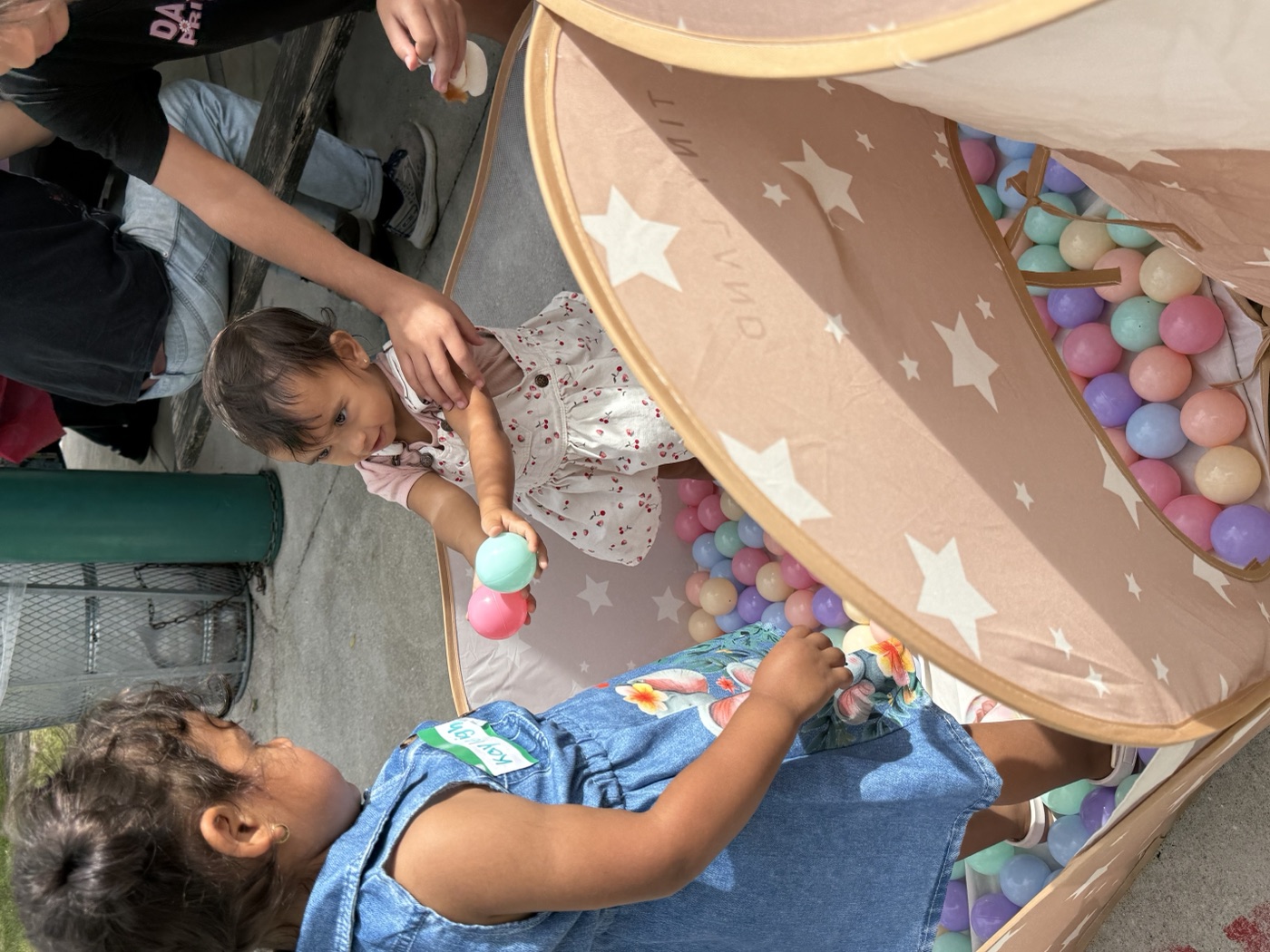 Pure delight — a child discovers the magic of our ball pit tent at a community e