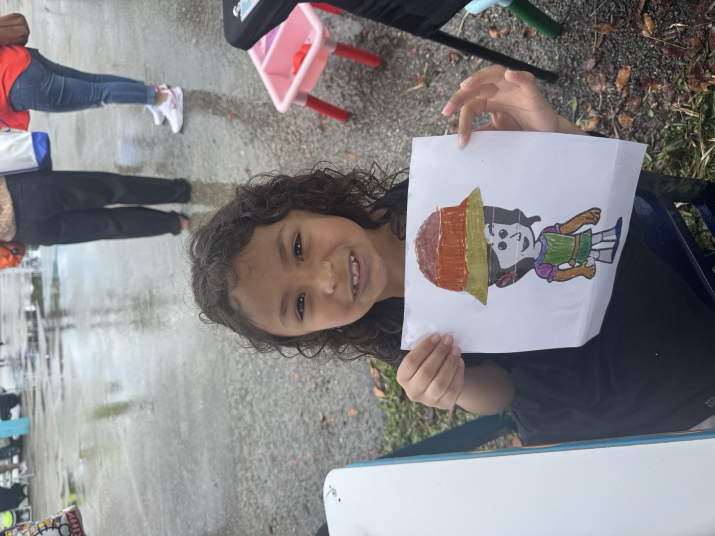 The characters come alive! A young fan holds up their hand-drawn version of thei