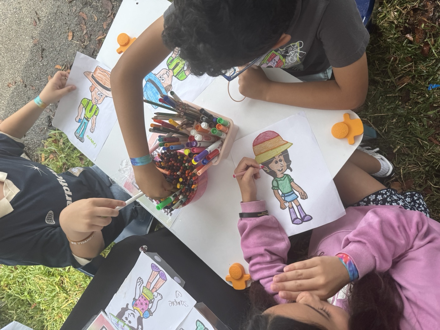 Color everything! A child goes all in on their masterpiece at our community tabl