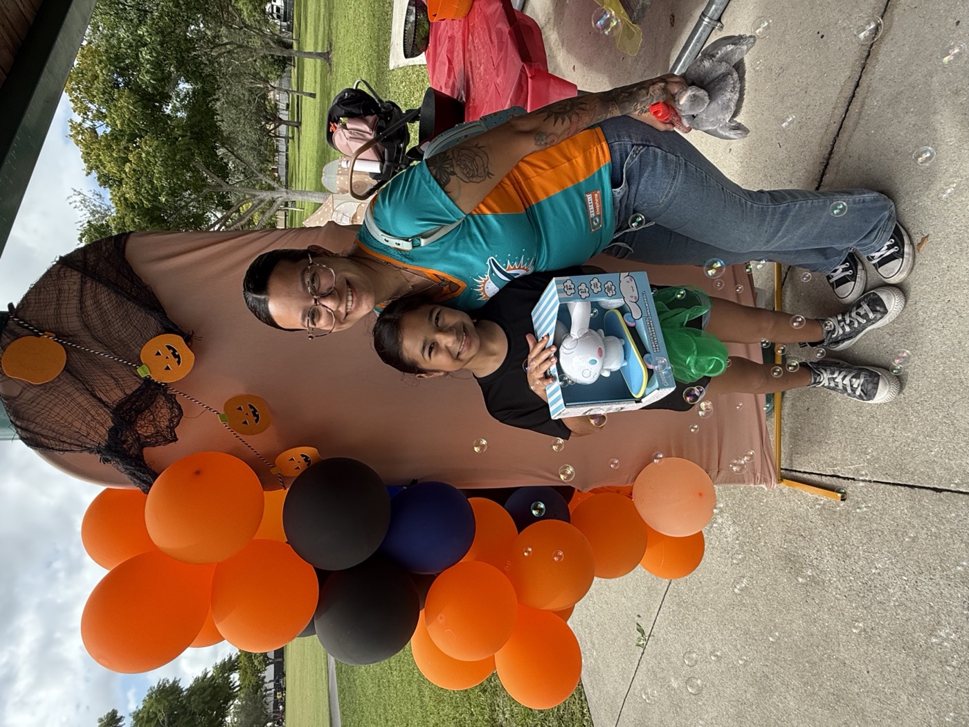 Outdoor crafting under the open sky — a child and caregiver enjoy our pop-up art