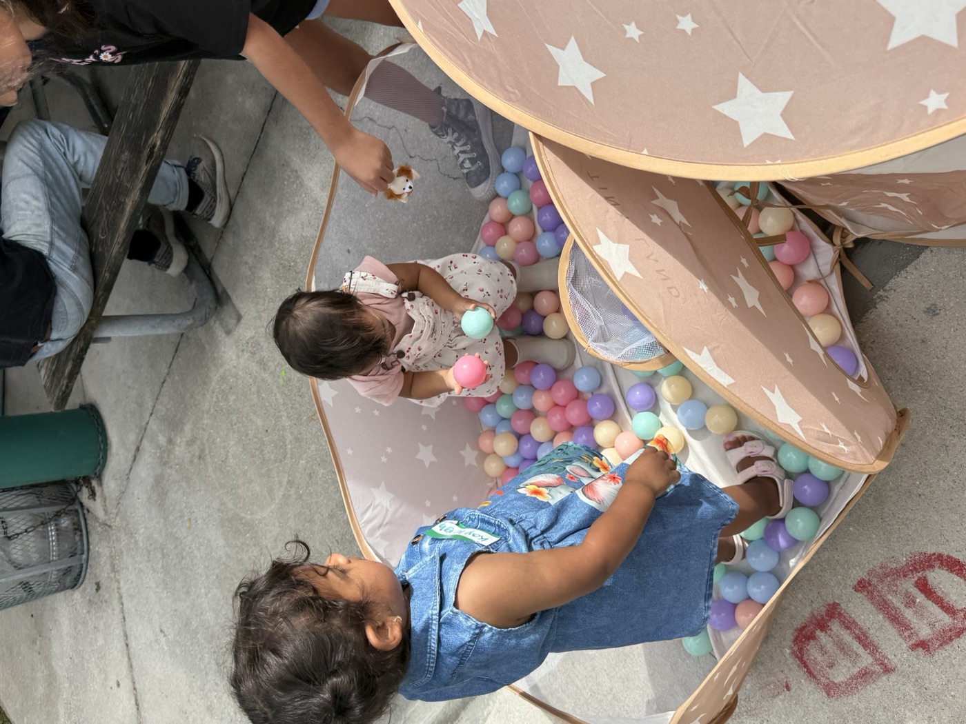 A moment of connection — a child and their grown-up enjoy our community event to