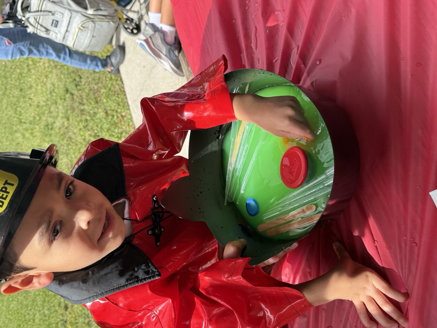 Ready, set, play! A child jumps into a game activity at our community booth.