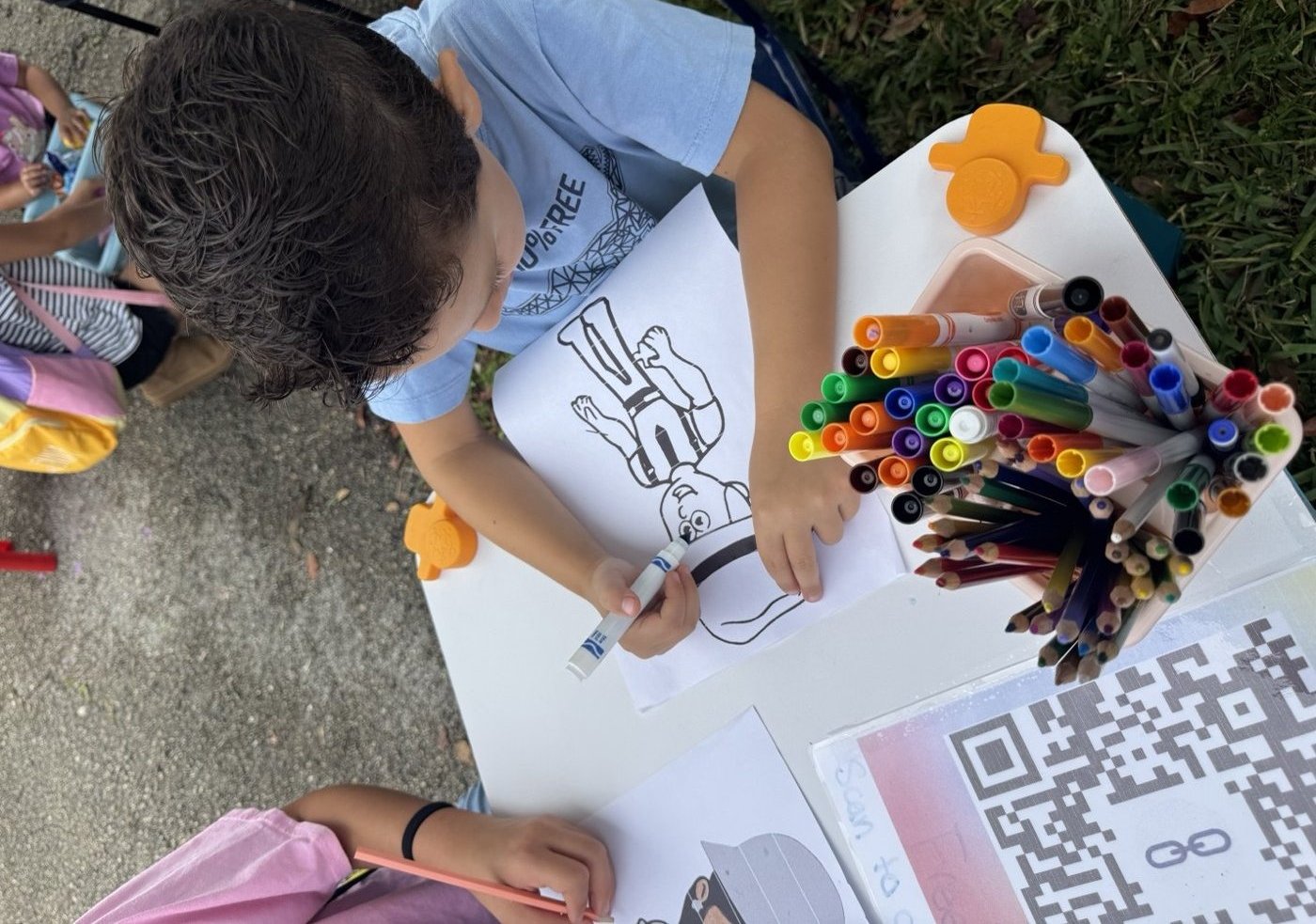 Artist at work — drawing at the table, focused and in their creative zone.