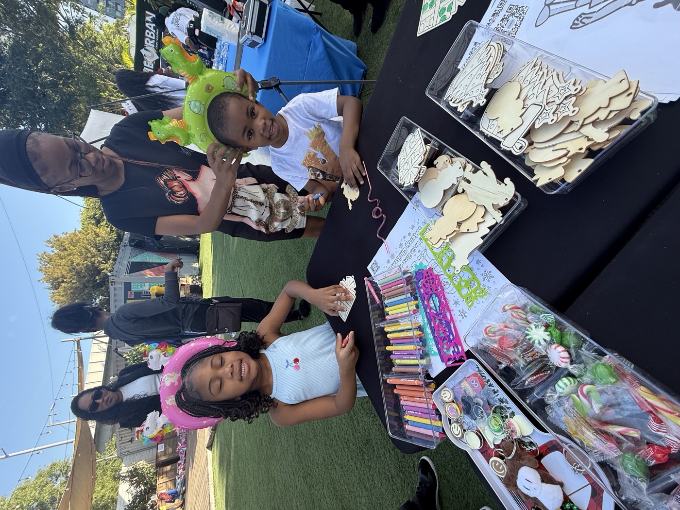 A colorful crew of young creators — hands full of art supplies and full of ideas