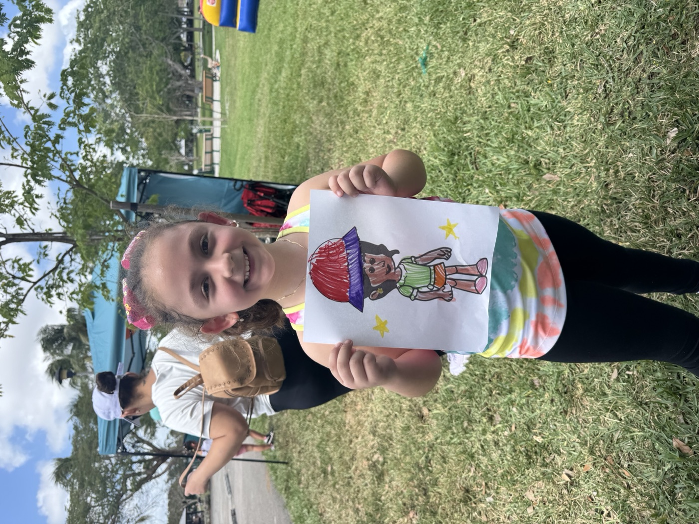 Artwork displayed with pride — another young artist shows what they made at our 