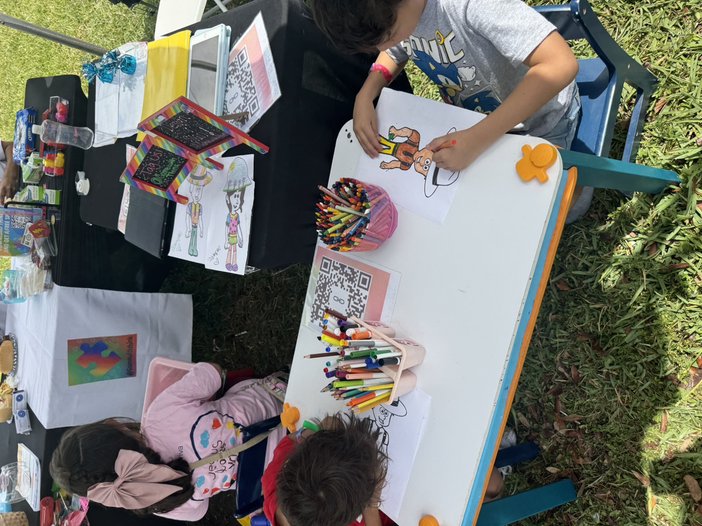 Pink outfit, pink focus — this girl was fully absorbed in her painting activity.